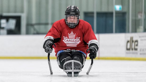 Dr. Peggy Assinck charges forward in her sled.
