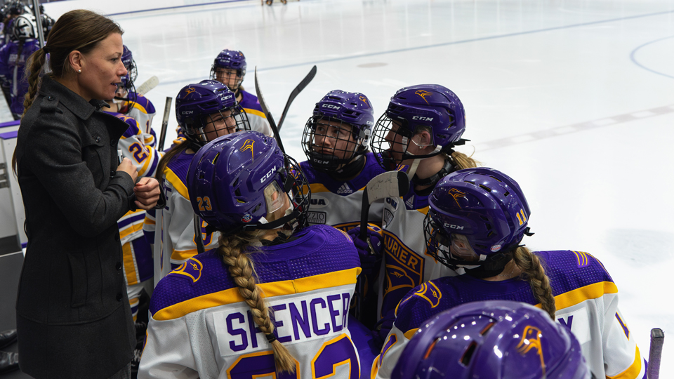 Kelly Paton coaches the Laurier women's team during a break in play.