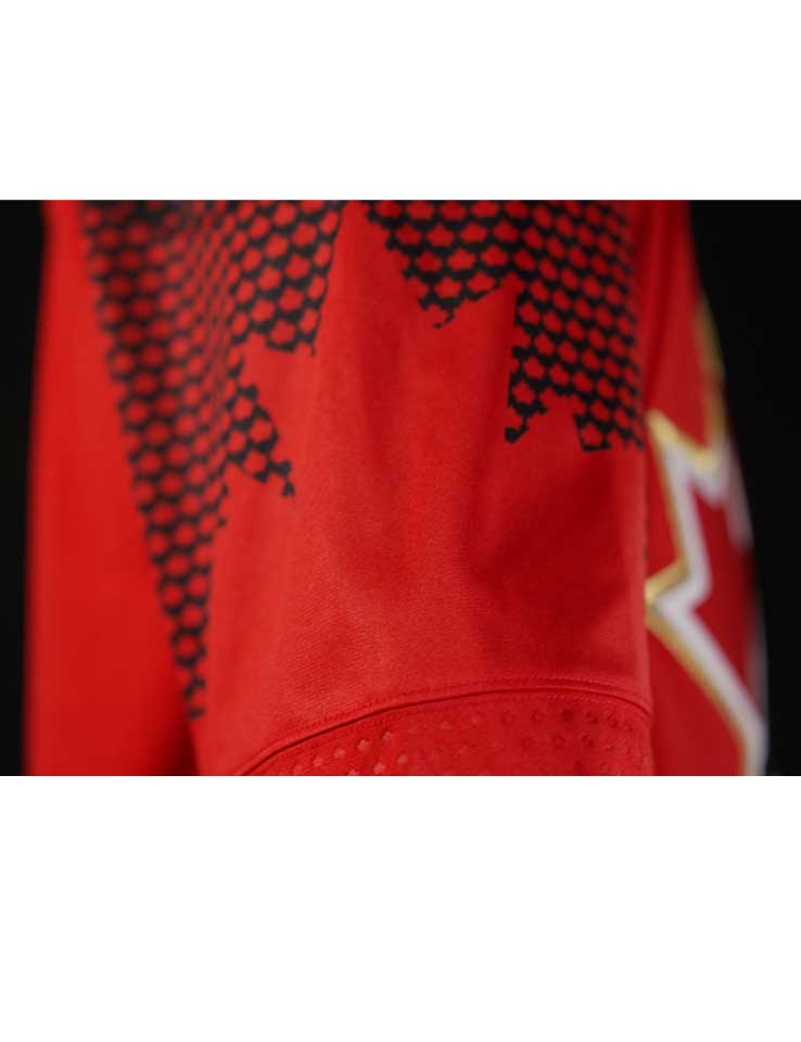 Side view showing sublimated red Maple Leaves across the shoulder yoke
