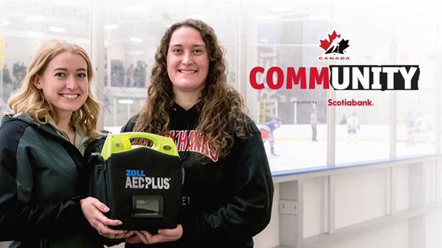 Blair Olsen and Haley Patyna holding an AED