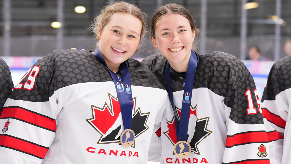 Marilou Grenier et Rosalie Breton, médaille de bronze au cou, posent avec le grand sourire.