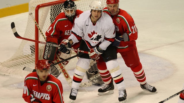 Team Canada captain Scott Niedermayer skates with the flag after