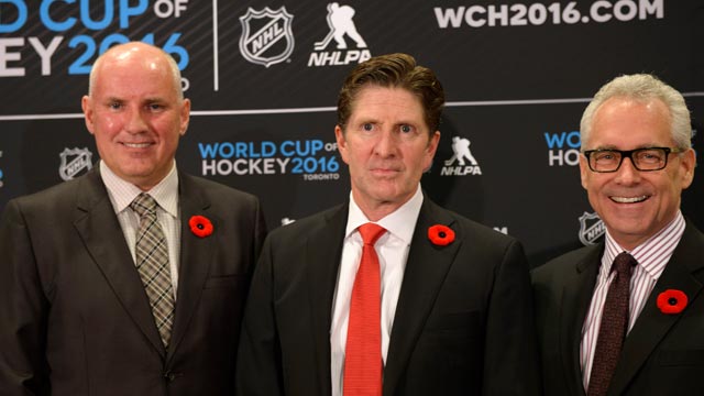 Colorado Avalanche head coach Joel Quenneville (R) wears his old