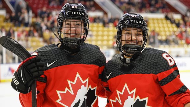 Julia and Nicole Gosling pose on the ice during warm-ups at the Rivalry Series game in Kitchener, Ontario.