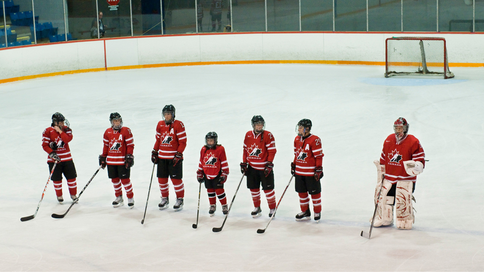 A 10-year-old Maggie Connors stands with the National Women's Team ahead of a game at the 2010 4 Nations Cup. Connors won a contest that let her a spend a day with Canada’s National Women’s Team.