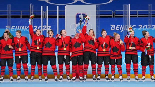 Canada’s National Women’s Team celebrating after receiving Olympic gold in Beijing