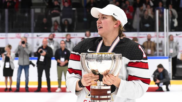 Brianne Jenner holds the IIHF Women's World Championship trophy on the ice after winning gold in 2022.