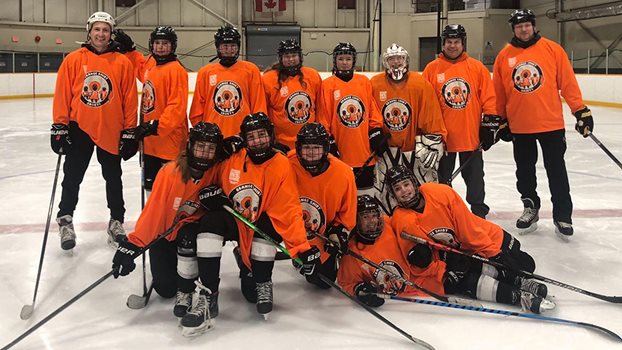 Minor hockey team wearing orange jerseys